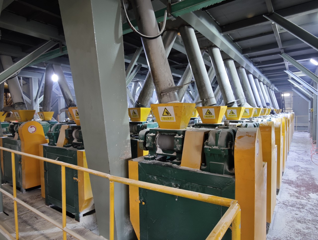 A row of integrated fertilizer granulation equipment in a production facility